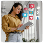 Woman using a tablet with business goals, social media, and shopping icons floating around her.
