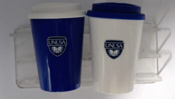 Two UNLSA-branded travel mugs, one blue with a white lid, one white with a blue lid.