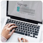 Hands typing on a laptop with a sign-up form to help achieve business goals.