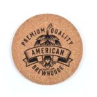 Round Cork Villa Coaster with American Brewhouse and hop cone graphic in black.