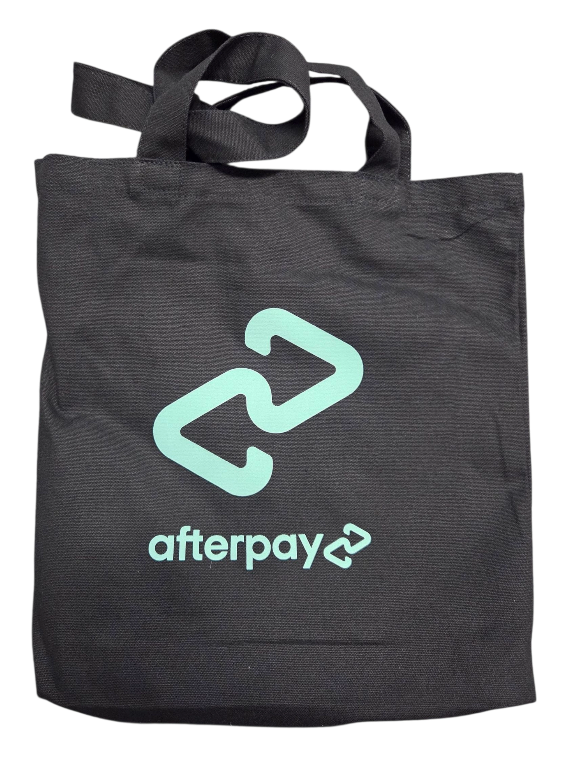 Black tote bag with mint green Afterpay logo, perfect for carrying conference items.