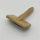 Deshedding Brush for Cats & Puppies with metal bristles, wooden handle, white background.