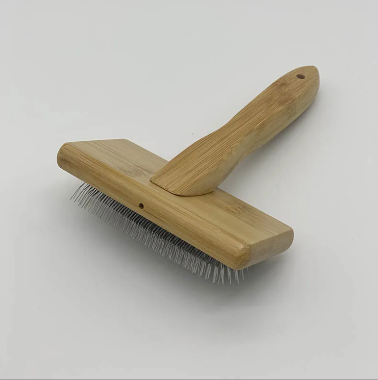 Deshedding Brush for Cats & Puppies with metal bristles, wooden handle, white background.