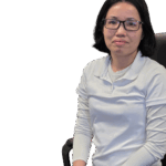Woman with glasses in a white shirt seated on a chair, showcasing promotional products.