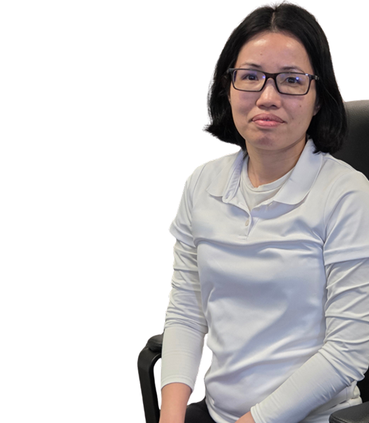 Woman with glasses in a white shirt seated on a chair
