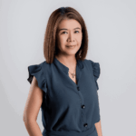 Woman with straight brown hair in a blue blouse, ideal for corporate Christmas gifts promo.