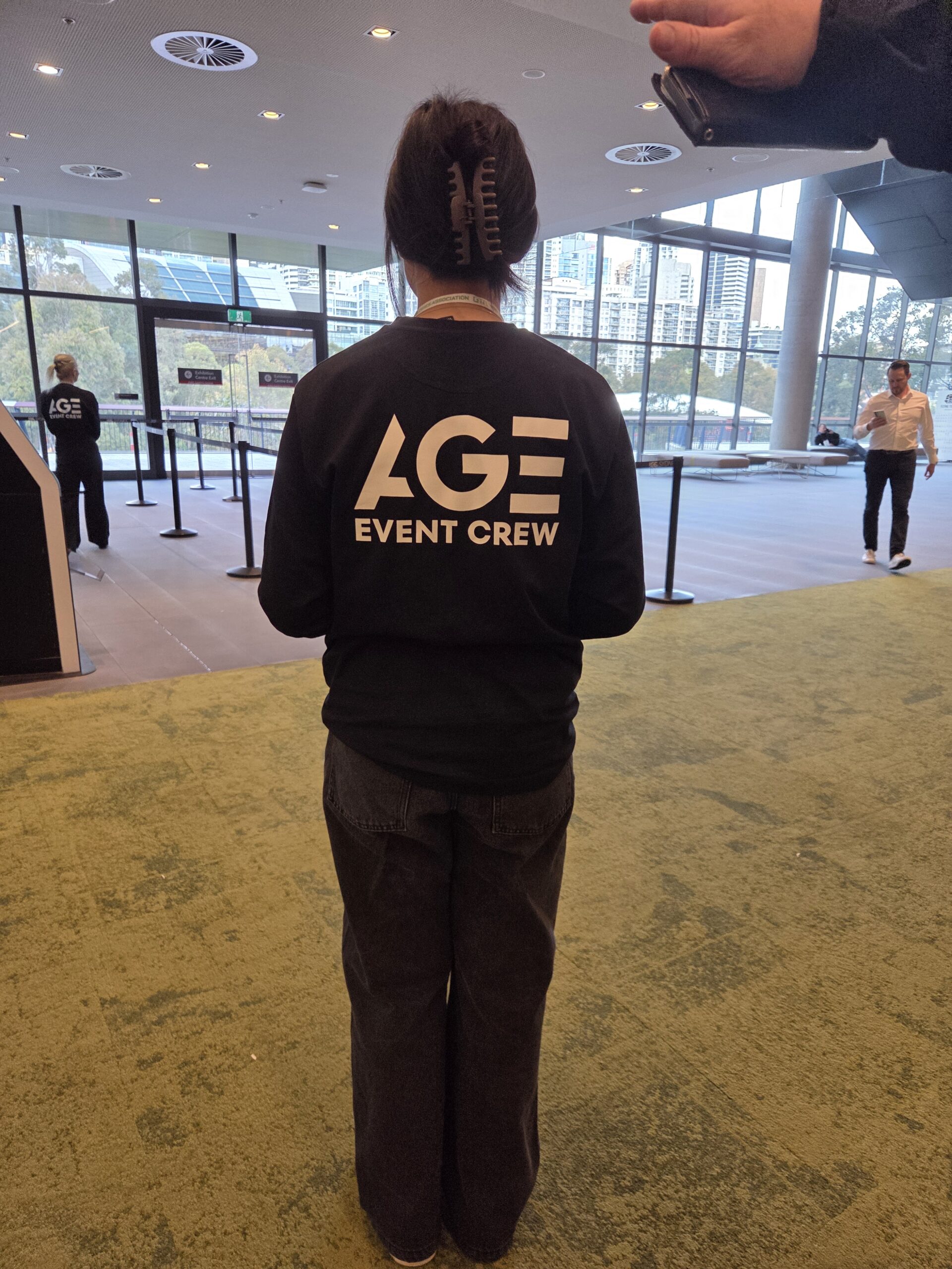 A person standing in a gaming room with a large window, ready for 2025.