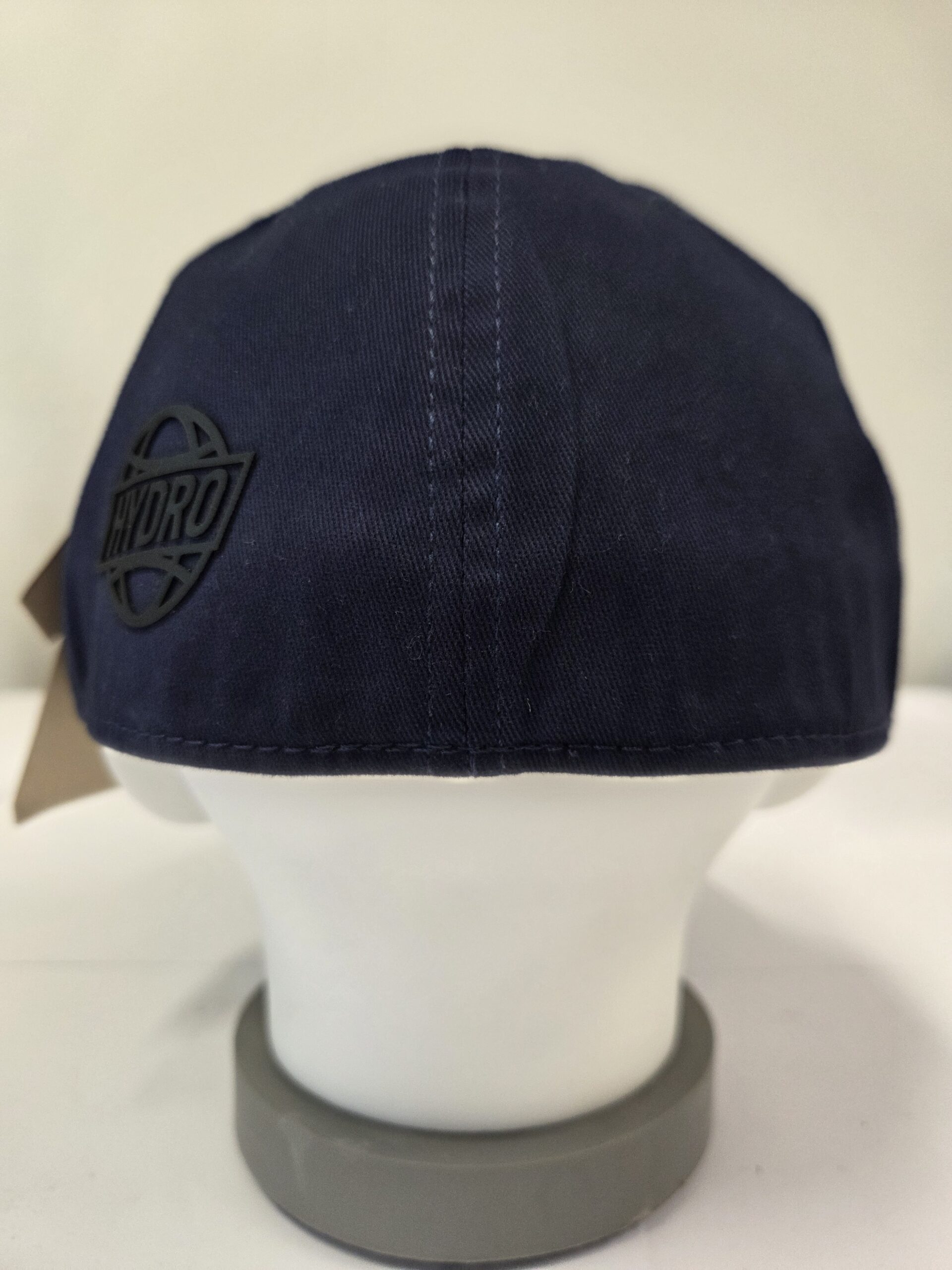 A navy blue branded cap with cap closures, shown on a mannequin head with Hydro logo.