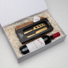 The Classic Pairing: gift box with red wine, cheese knife set, and a wooden board.
