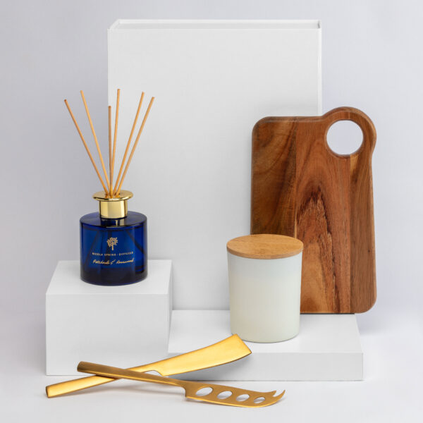 The Curated Host Hampers—elegant gift set of diffuser, candle, and cheese knives on display.