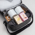 Open bag with two mugs, hot chocolate & marshmallows—The Corporate Comfort Collection.