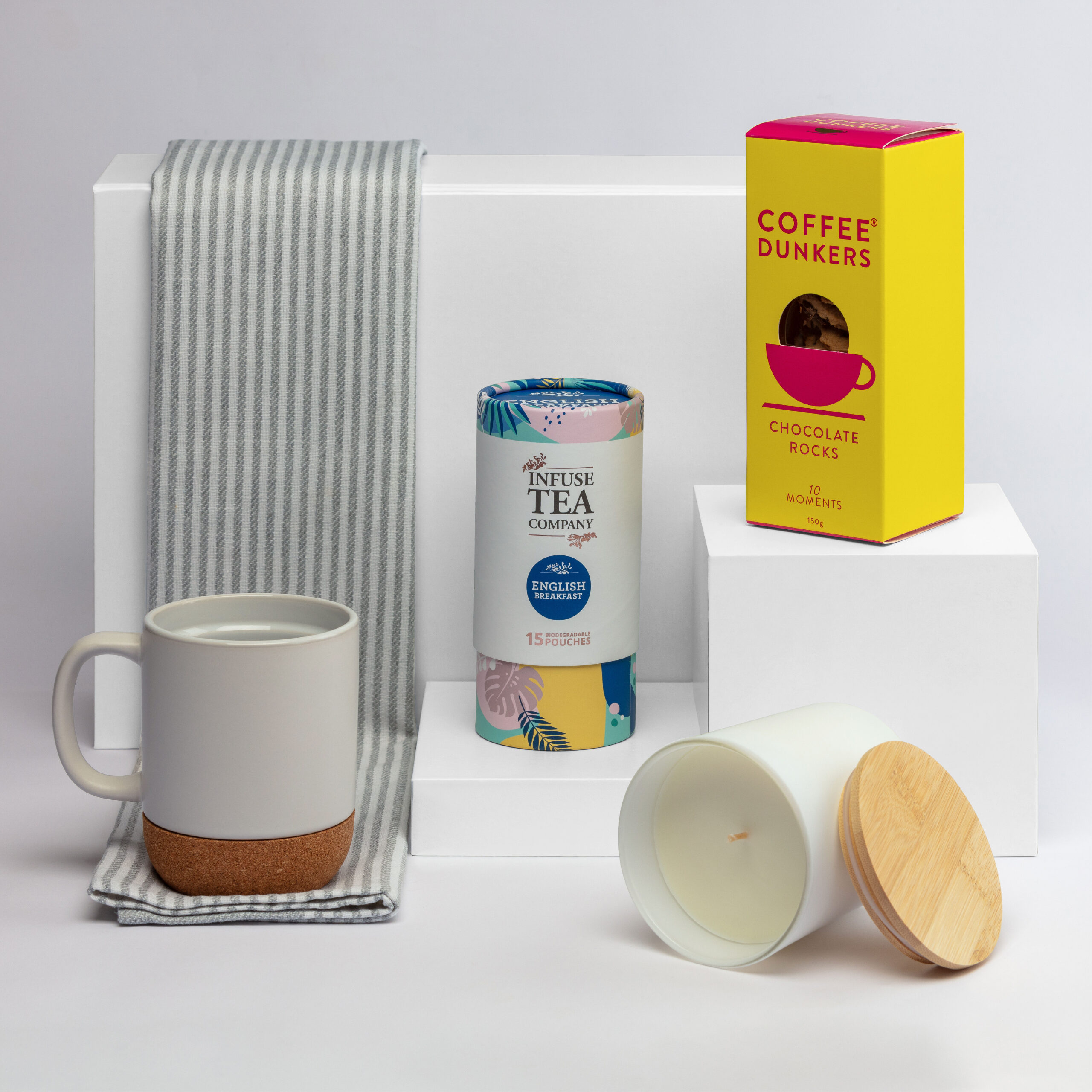 The Morning Ritual Hamper: Includes mug, tea, chocolate, candle, and a striped towel.