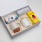 The Morning Ritual Hamper: Includes 2 mugs, a towel, tea tin, and chocolate coffee dunkers.