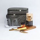 The Partnership Graze Packs: gray picnic bag, snacks, glasses, crackers, jam, cheese, knife & board.