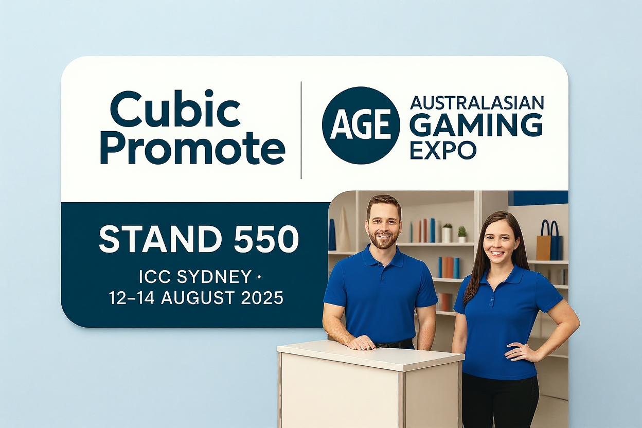 Two people in gaming industry uniforms stand by a Cubic Promote sign at Australian Gaming Expo 2025.