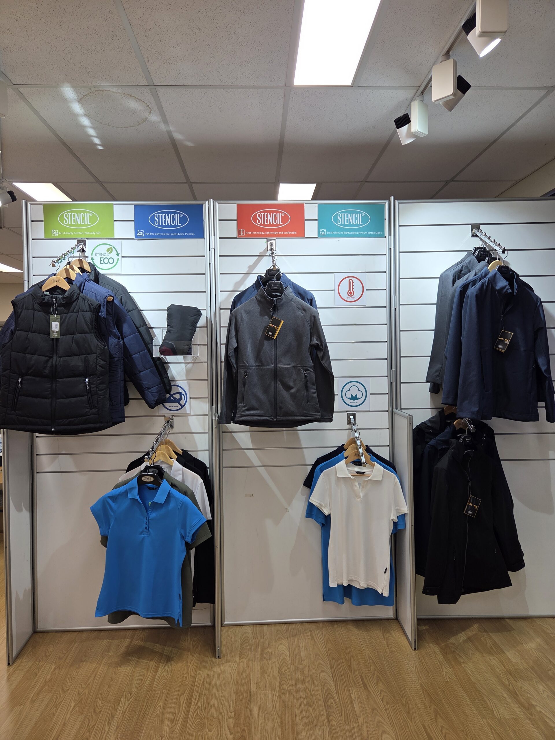 Clothing display with jackets, shirts, and polos on hangers highlights apparel case studies.