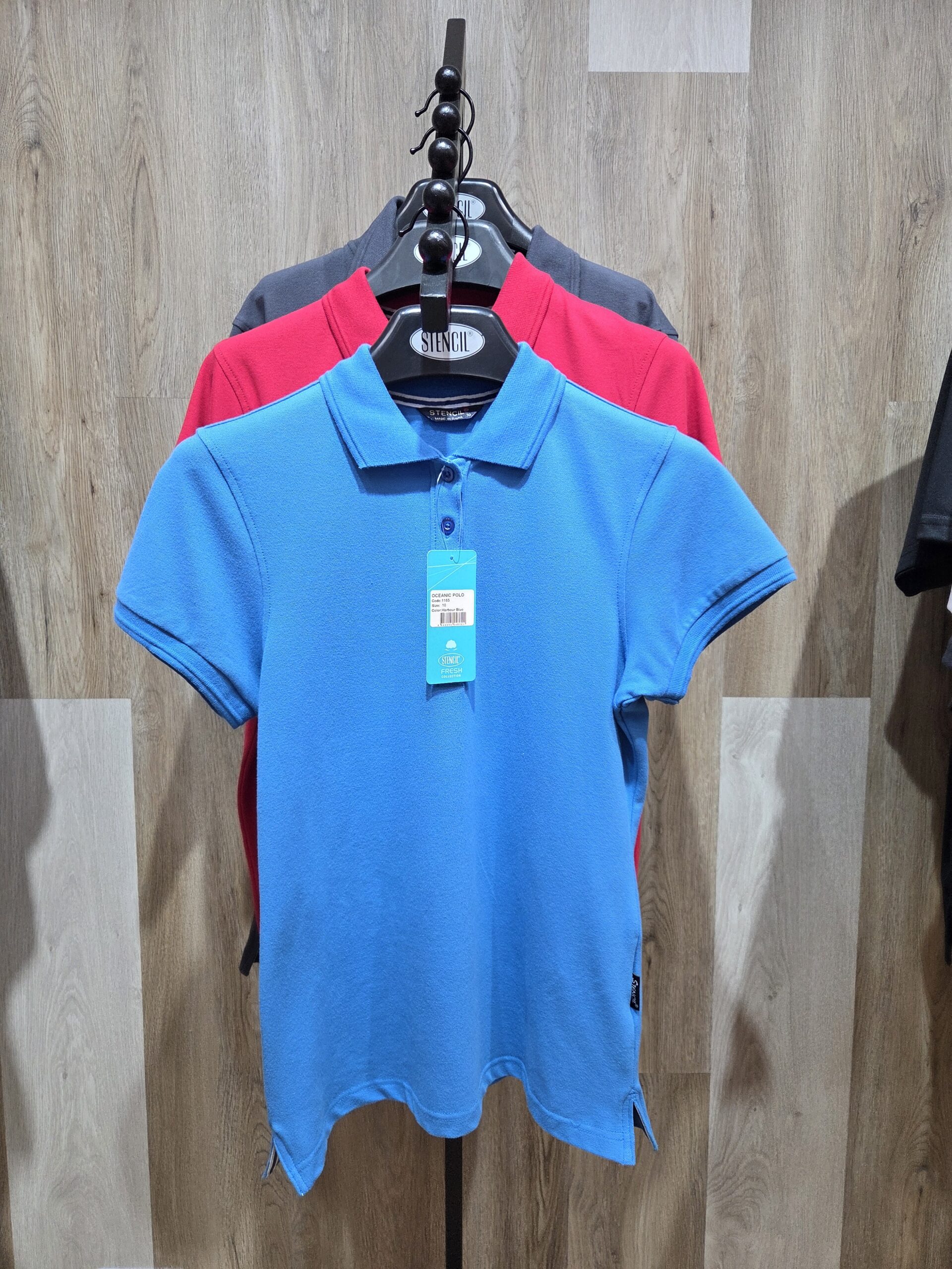 Three polo shirts on a rack showcase classic style—perfect for apparel case studies.