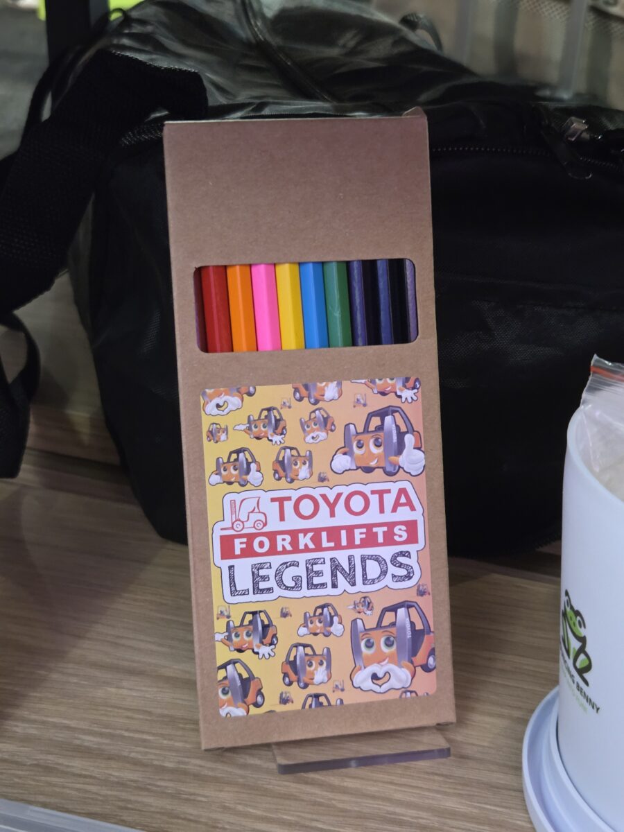 A box of colored pencils labeled Toyota Forklifts Legends with cartoon dog graphics.