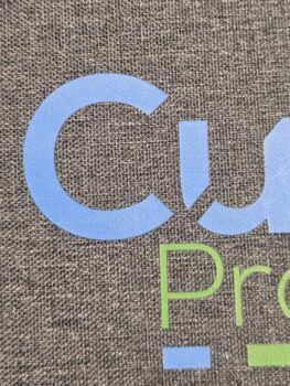 Partial text Cu in blue and Pro in green on a textured gray background, perfect for branding notebooks.