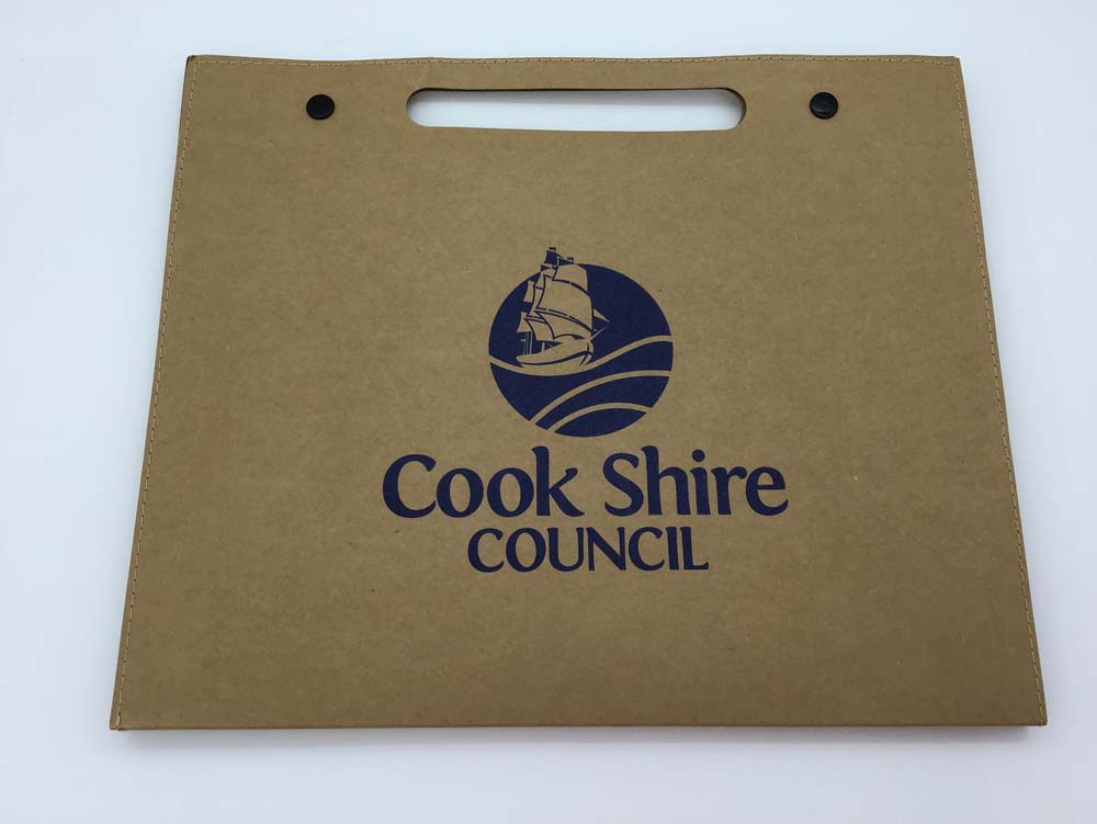 Brown government folder with Cook Shire Council and a blue ship logo printed on the front.