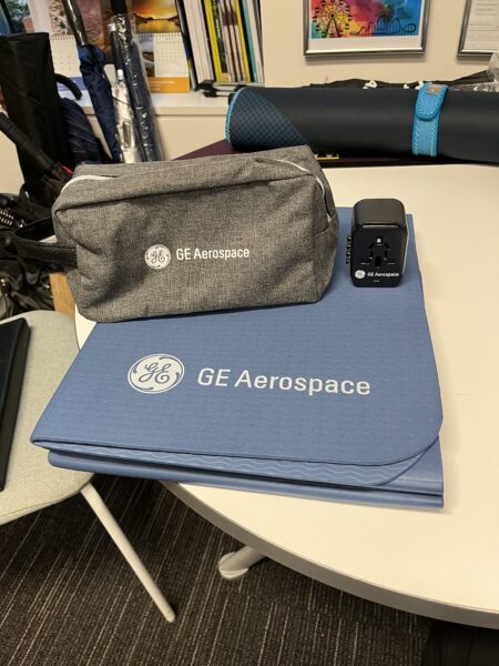 GE Aerospace branded pouch, charger, and blue mat
