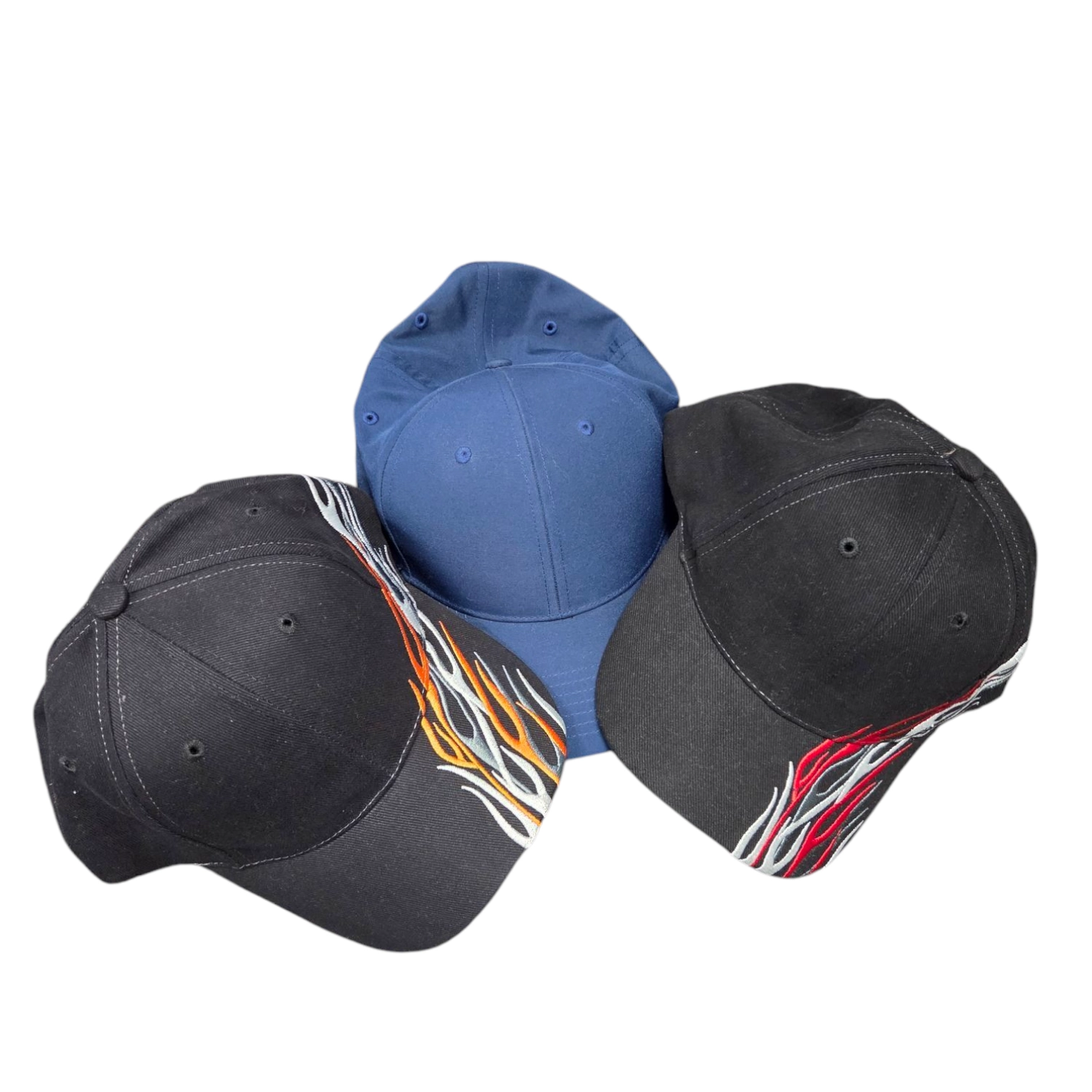 Three baseball caps: two black with flames, one plain blue—case studies of custom caps.