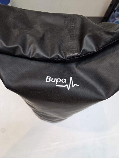 Black Bupa sports gym bag with a heartbeat line and logo printed in white.