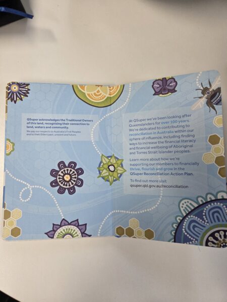 A brochure with floral Aboriginal art and text about QSuper’s reconciliation commitment.