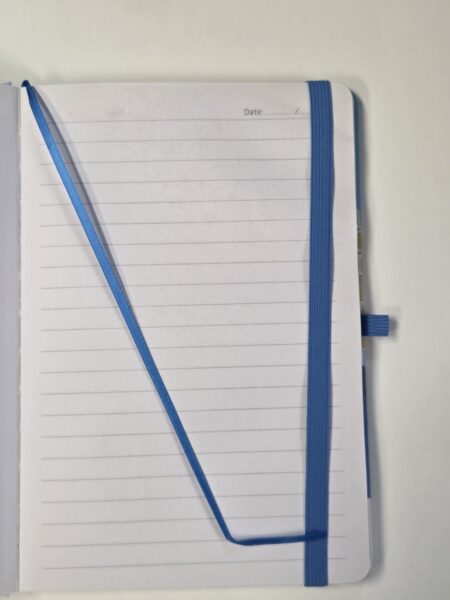 Open lined qsuper notebook with blue elastic band and ribbon on a white background.