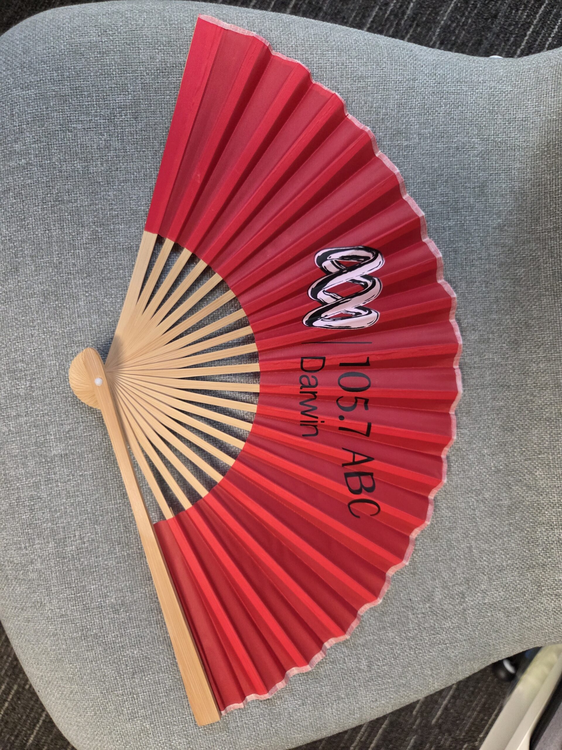 red fan with 105/7 ABC's logo
