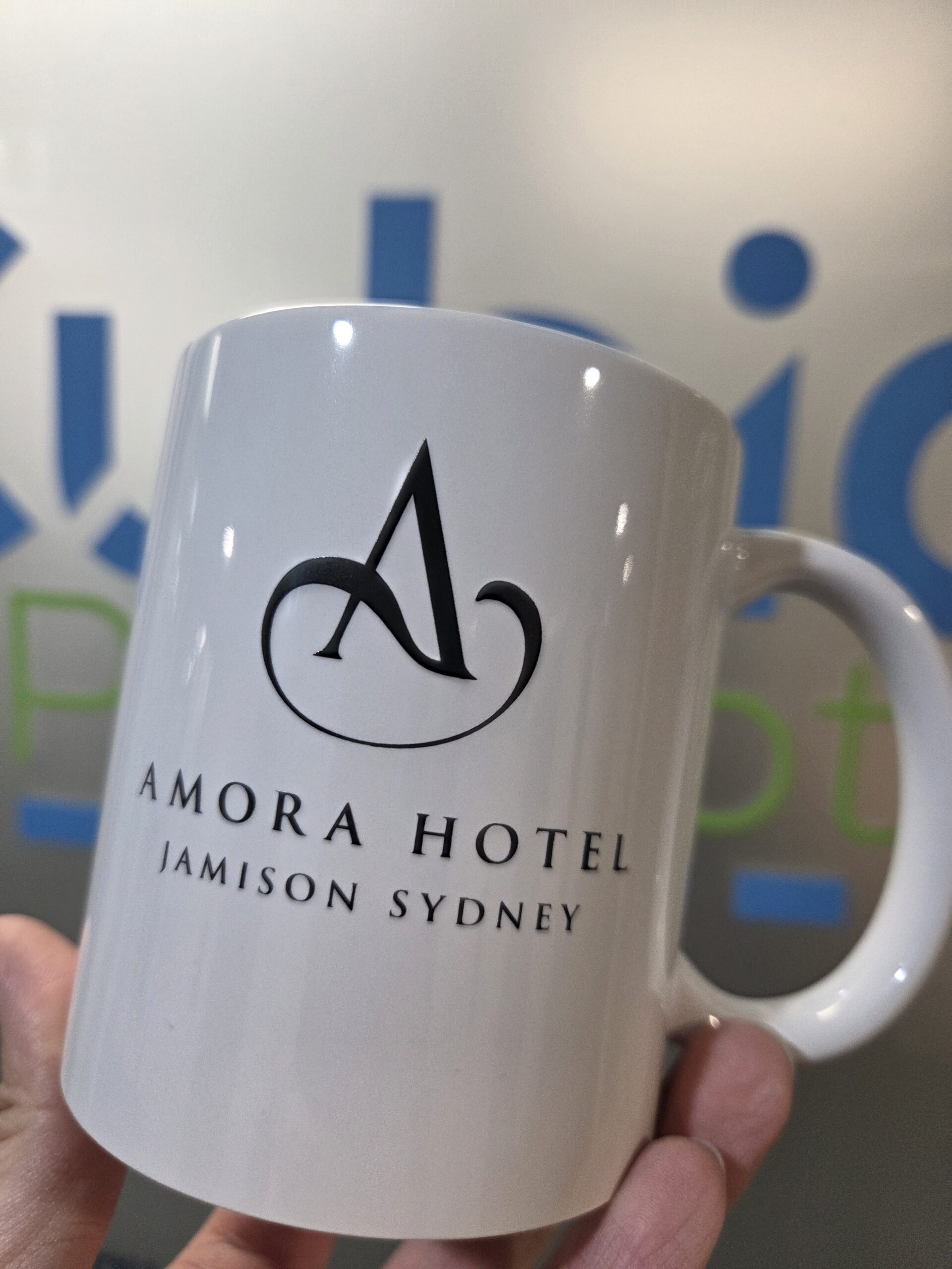 white mug with Amoral Hotel logo and text