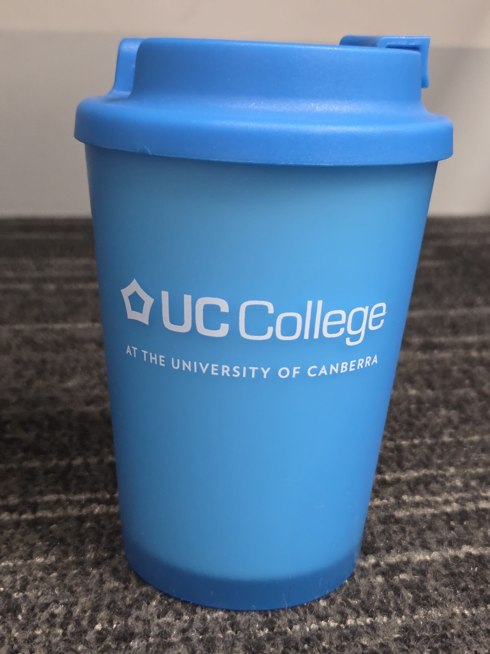 blue cup with lid for UC College