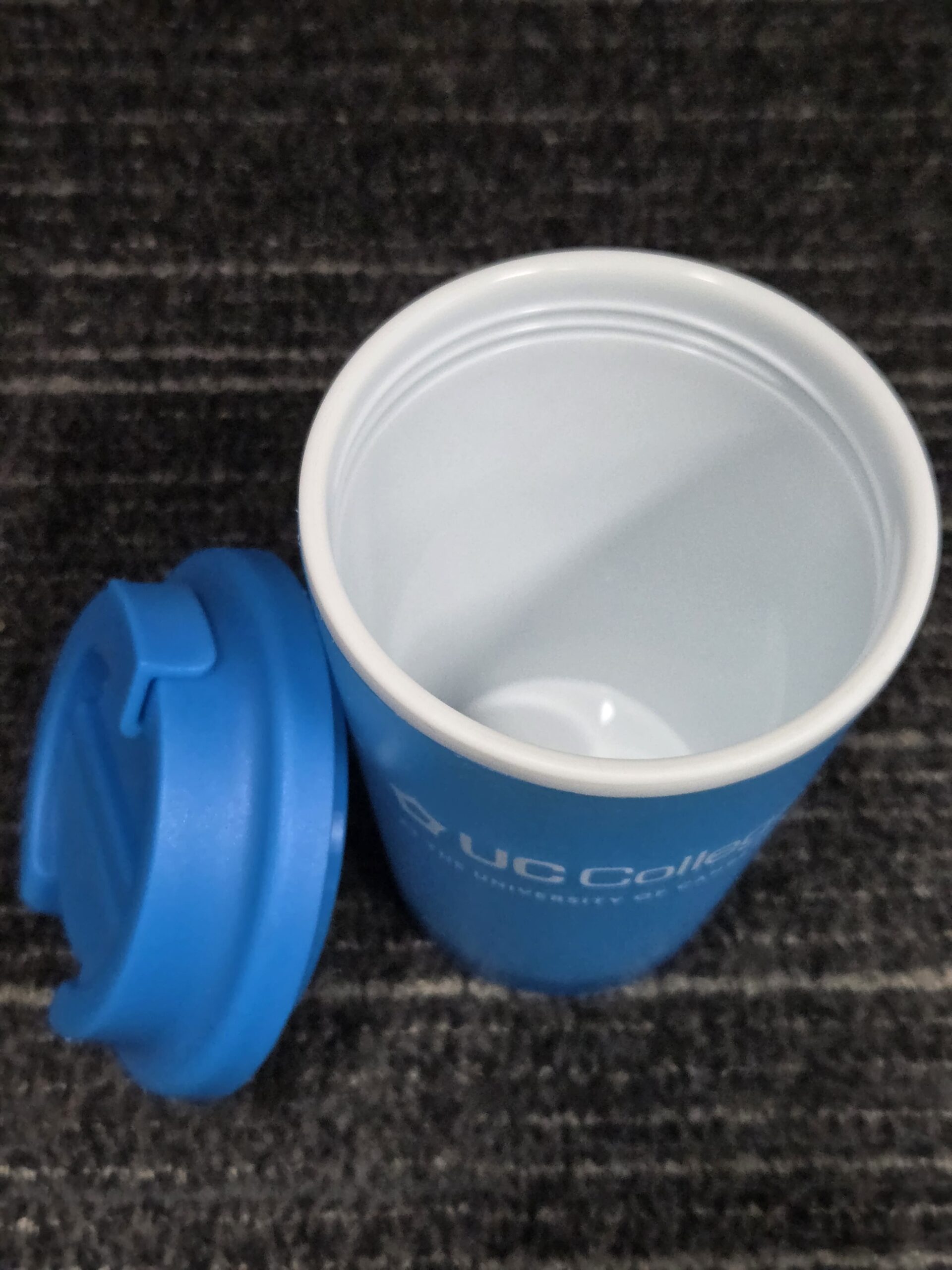 blue cup with lid on the side
