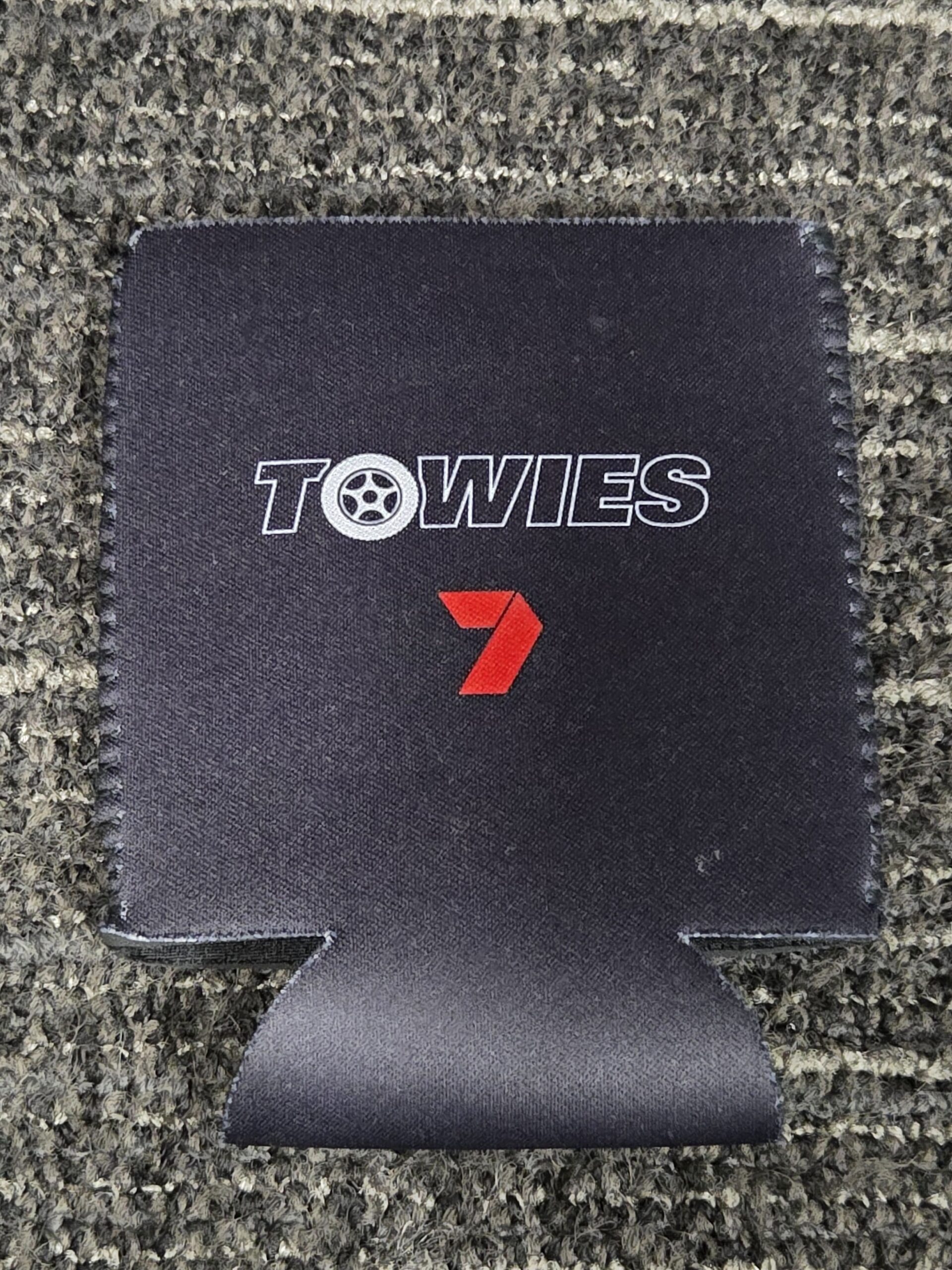 black stubby cooler with TOWIES logo
