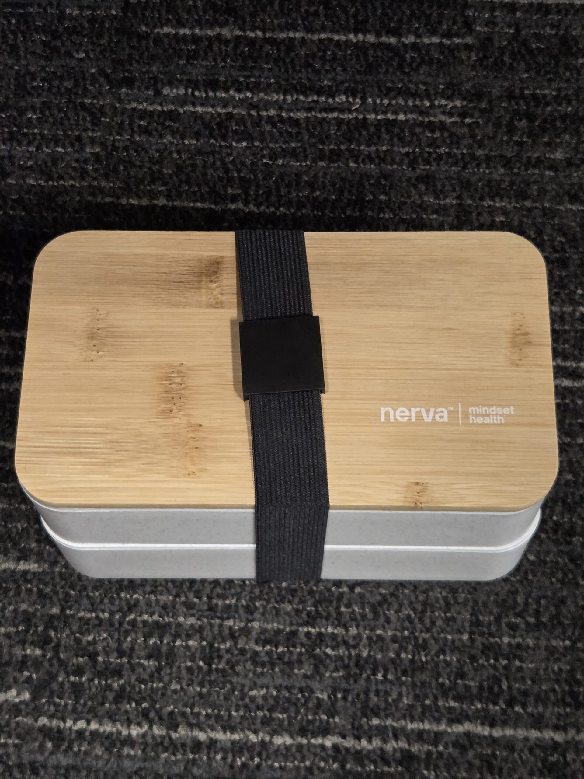 lunch box with black strap and Mindset Health logo printed in white