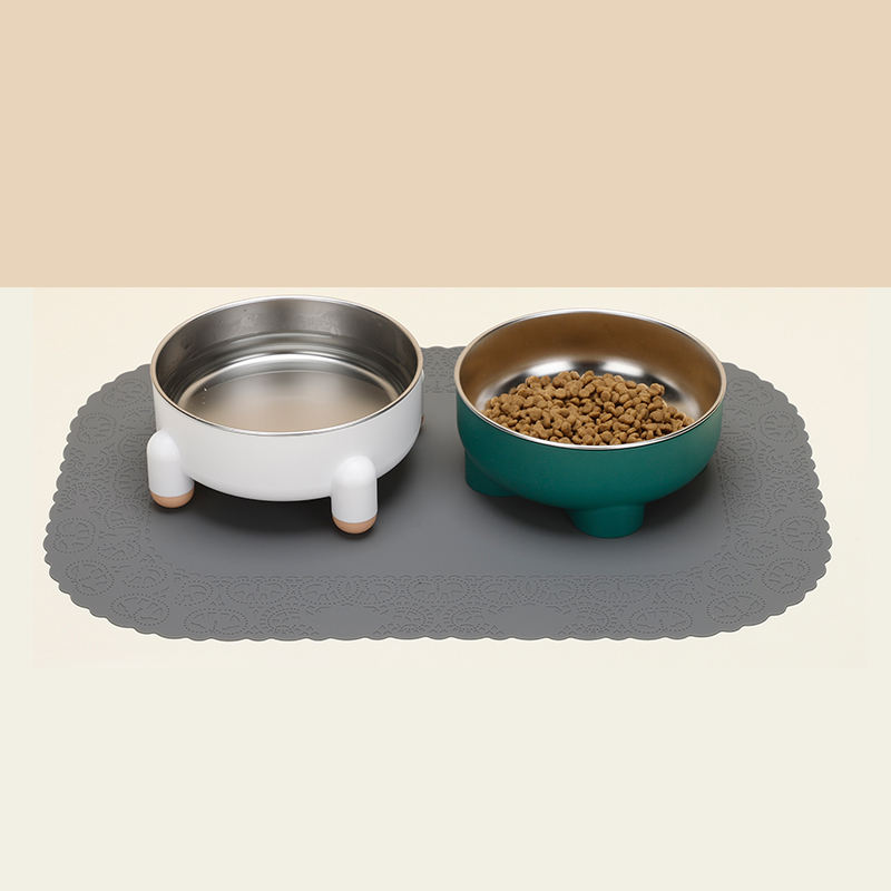 Two pet bowls on a Custom High Edge Silicone Pet Feeding Mat, one with water, one with kibble.