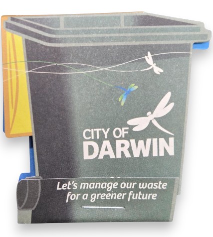 A waste bin with City of Darwin, dragonflies, and promotional seedsticks for greener waste.