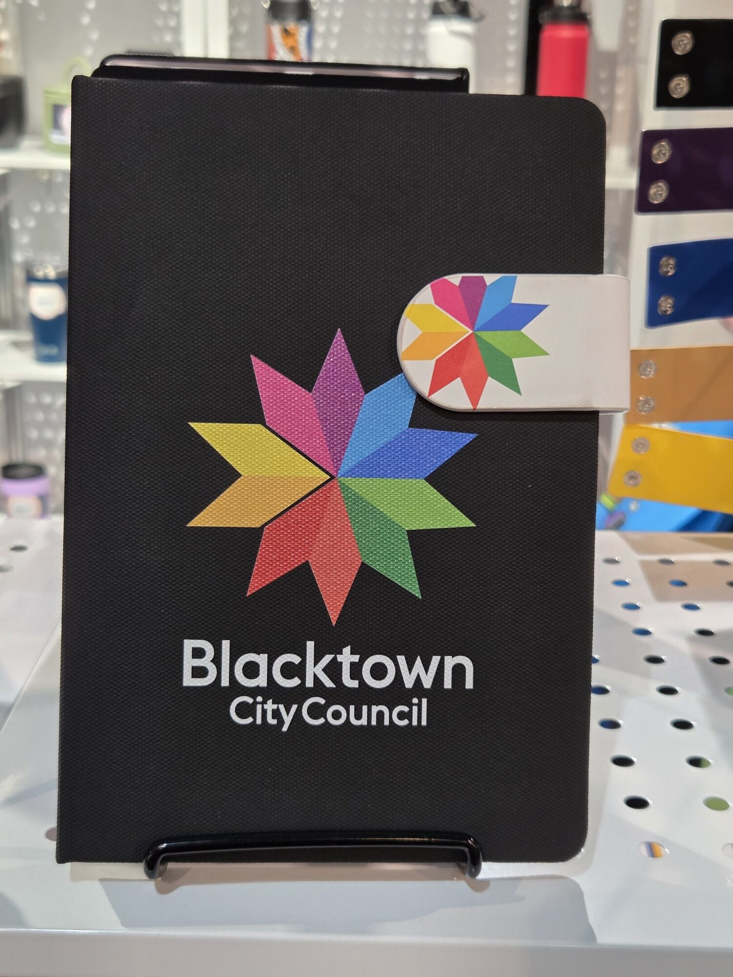 Blacktown City Council notebook with a colorful star logo on the black cover.