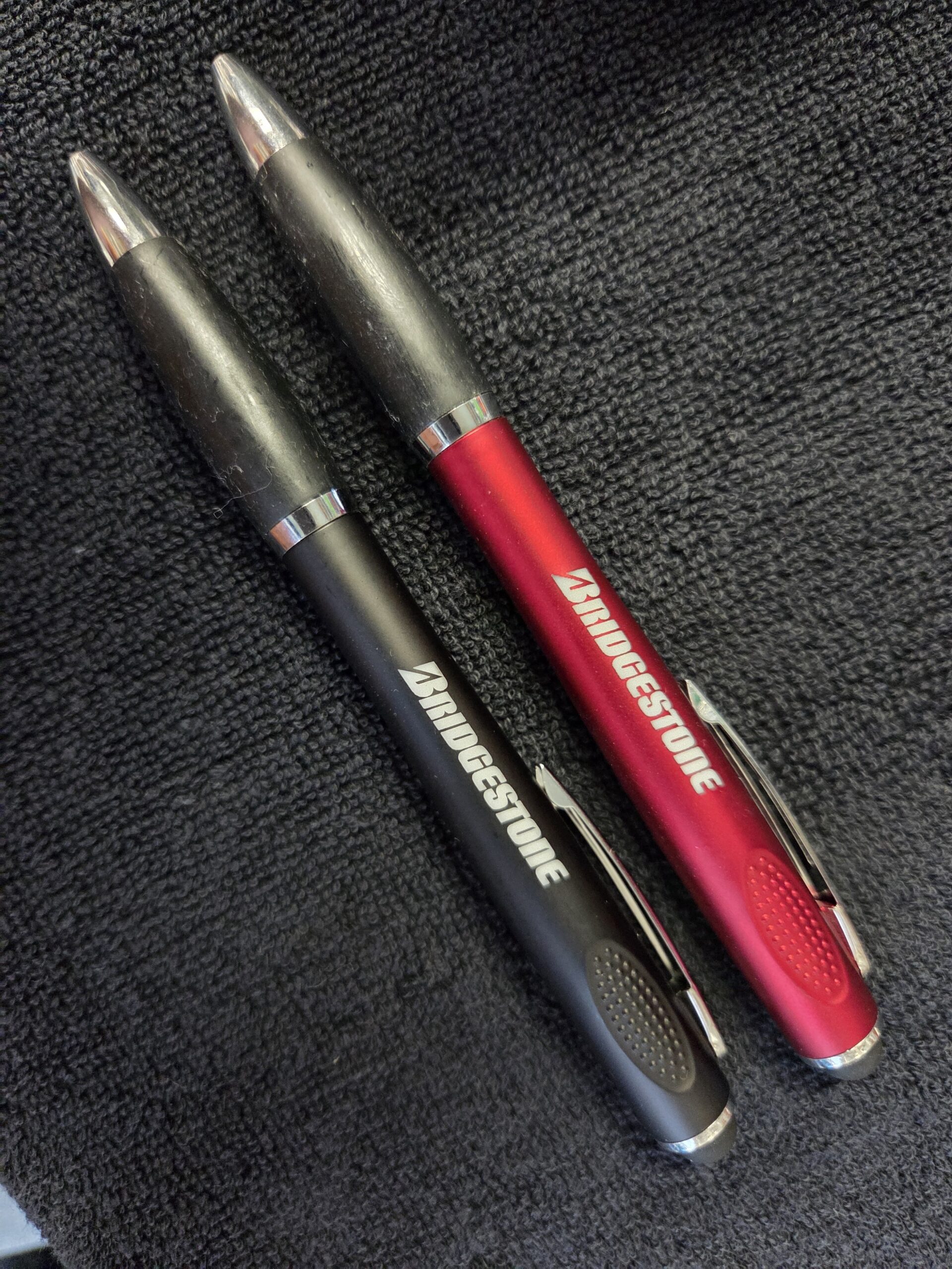 two pens coloured red and black with birdgestone logo