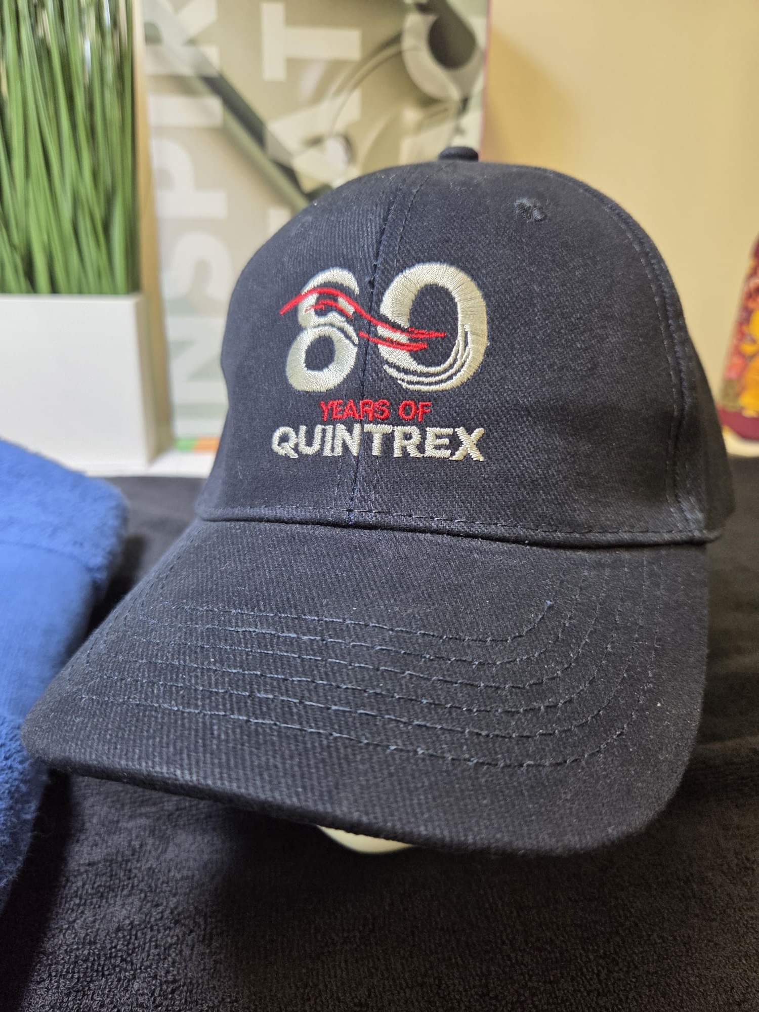 A navy blue Quintrex cap with 80 Years of Quintrex embroidered on the front.