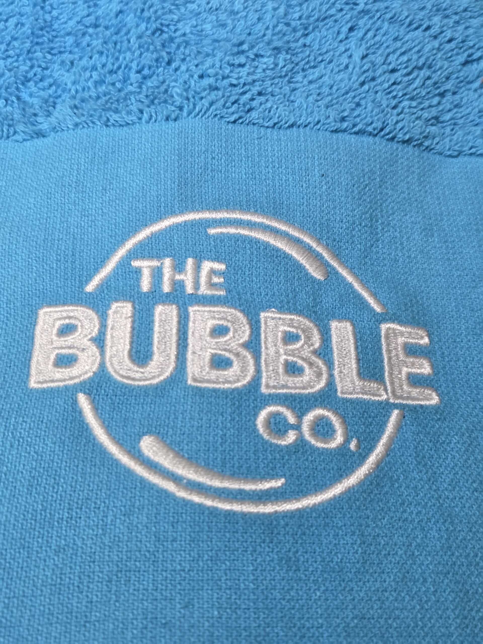 Blue towel featuring the Bubble Co logo, perfect for sharing your next client story.