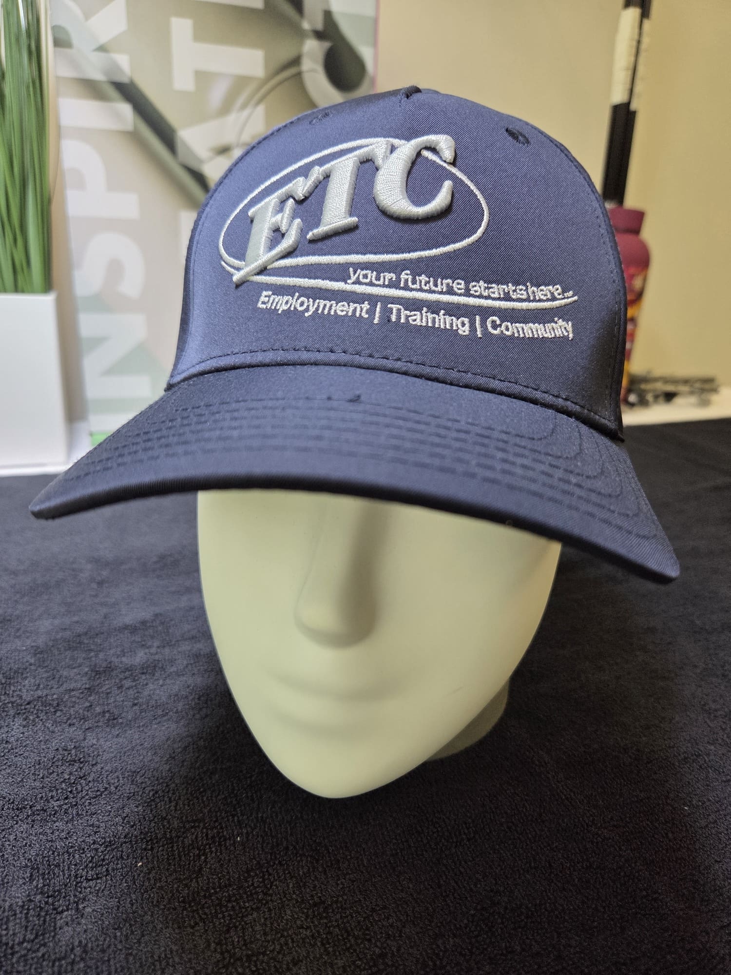Navy blue ETC hat on a mannequin head, perfect for your next client story or case study.