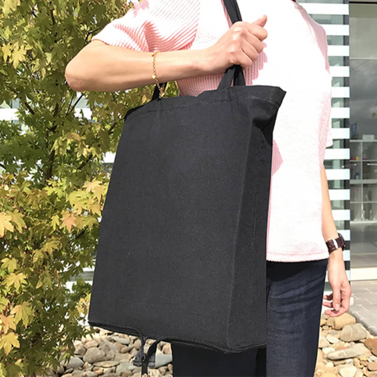 Person holding Event Eco Calico Bags - rush outdoors—ideal for busy days or events.