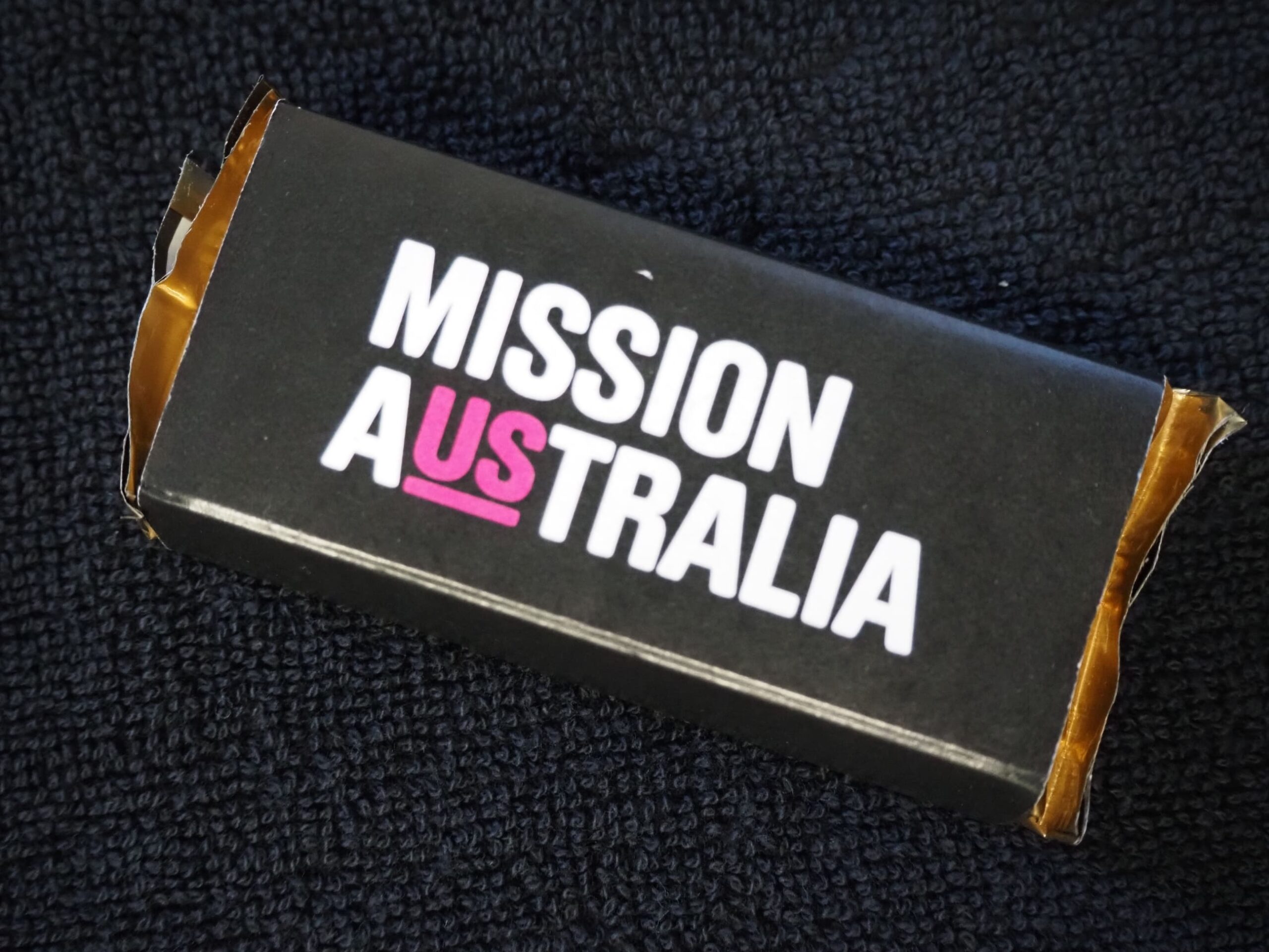 A black box labeled MISSION AUSTRALIA, spotlighting a Client Story with US highlighted in pink.
