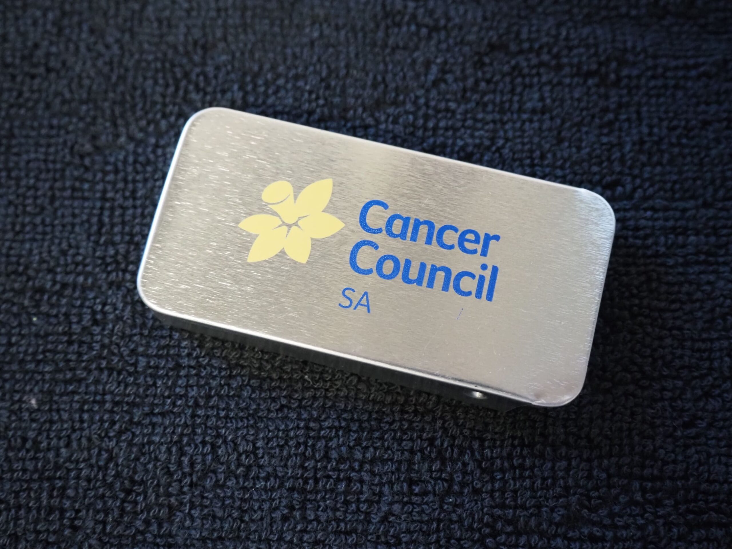 Rectangular metal tin with Cancer Council SA logo, supporting cancer support in South Australia.
