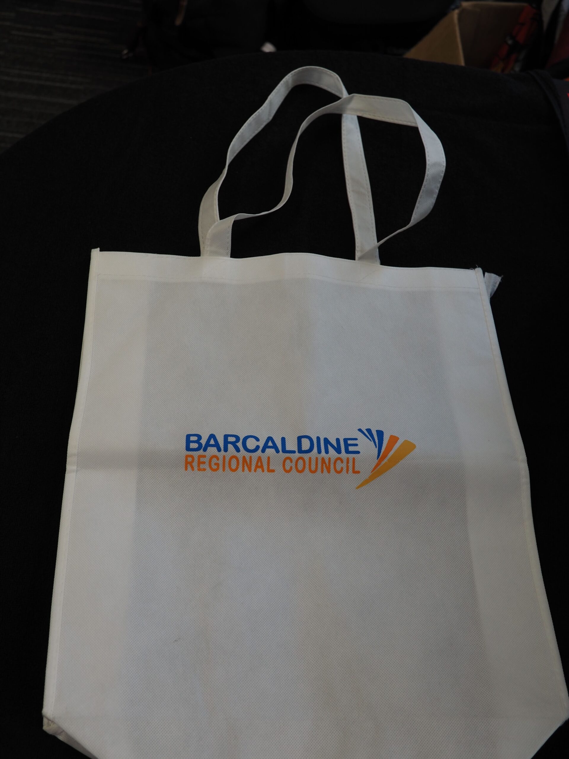 White tote bag featuring the Barcaldine Regional Council logo in striking blue and yellow text.