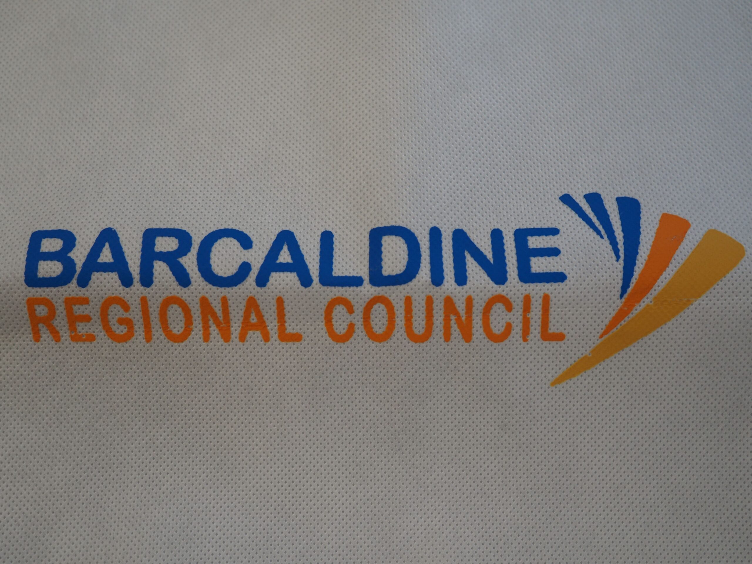 Barcaldine Regional Council logo with blue and orange text and stylized council shapes.