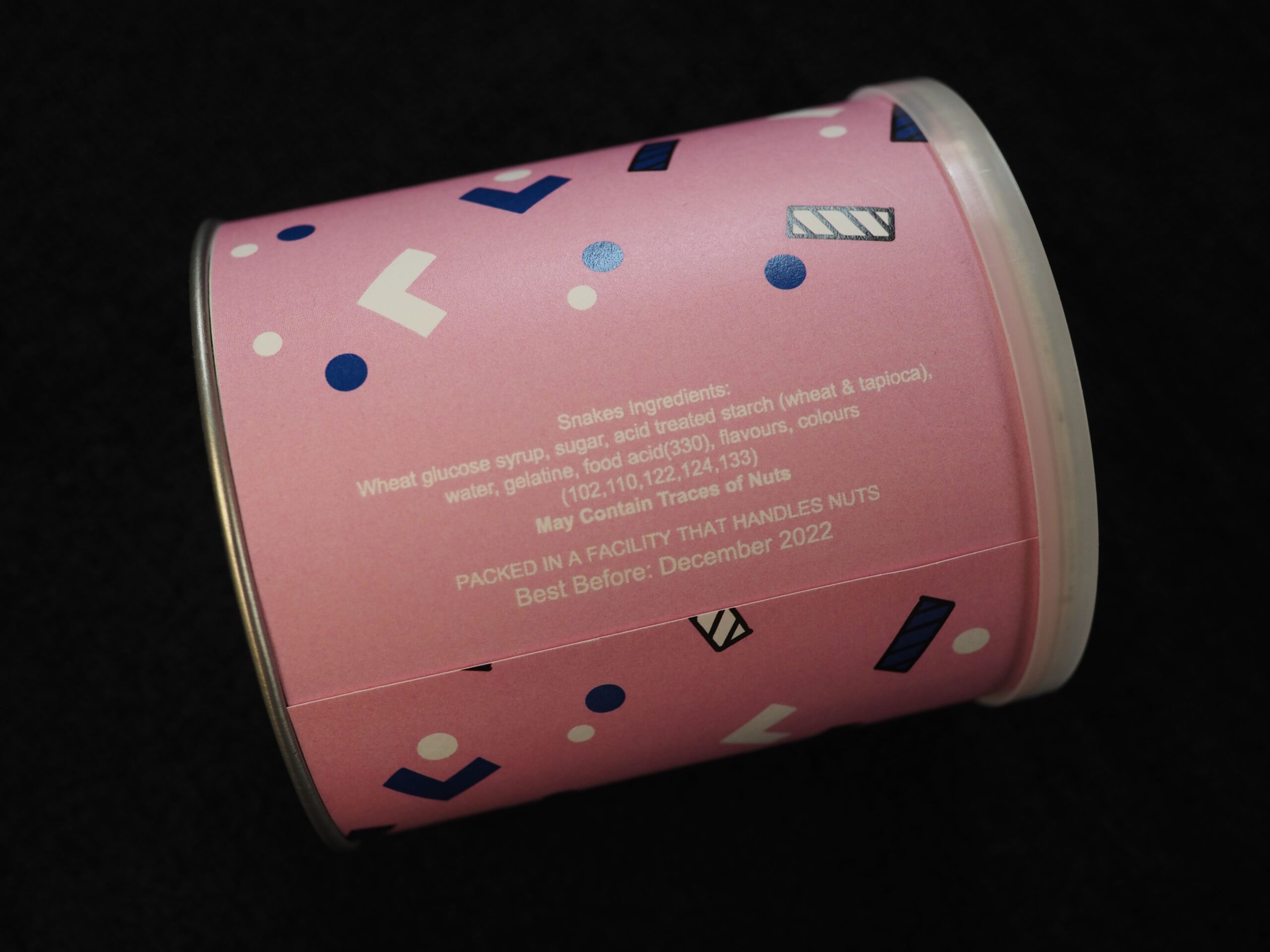 Pink container with geometric patterns, featuring LatitudePay info and visible white ingredient details.