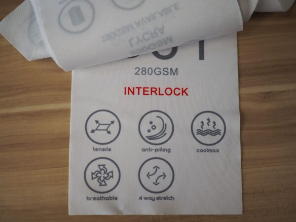 White polo fabric swatch with INTERLOCK and six fabric feature icons with descriptions.