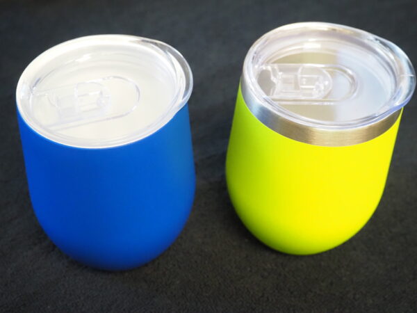 Two travel-friendly corporate gifts: blue and yellow insulated tumblers with clear lids.